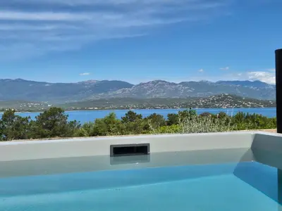 a swimming pool with a view of the water at Résidence Alt'aria in Porto-Vecchio