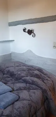 a bedroom with a bed with a motorcycle on the wall at Résidence Alt'aria in Porto-Vecchio