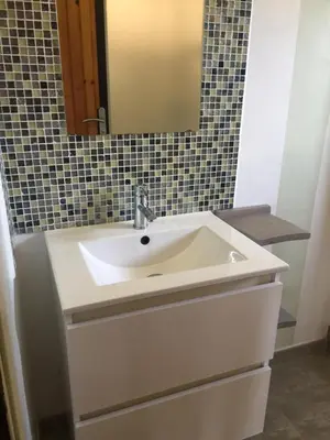 a bathroom with a white sink and a mirror at Résidence Alt'aria in Porto-Vecchio
