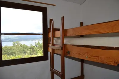 two bunk beds in a room with a window at Résidence Alt'aria in Porto-Vecchio