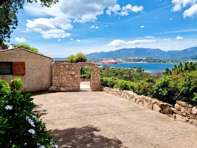 a stone house with a view of the water at Résidence Alt'aria in Porto-Vecchio