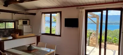a kitchen with a table and a view of the ocean at Résidence Alt'aria in Porto-Vecchio