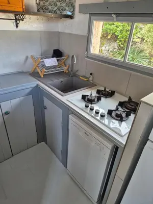 a small kitchen with a sink and a stove at Résidence Alt'aria in Porto-Vecchio