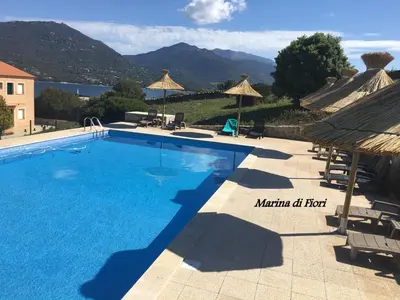 a swimming pool with a view of the mountains at Marina di fiori in Propriano