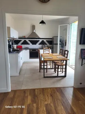 a kitchen with a table and chairs in it at T3 Ajaccio vue mer in Ajaccio