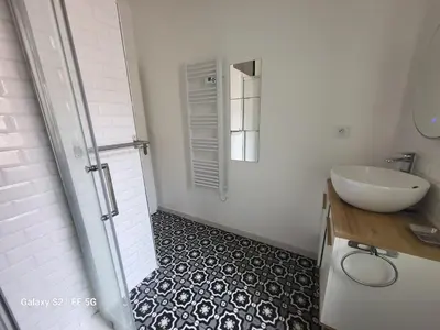 a white bathroom with a sink and a shower at T3 Ajaccio vue mer in Ajaccio