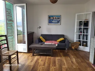 a living room with a couch and a table at T3 Ajaccio vue mer in Ajaccio