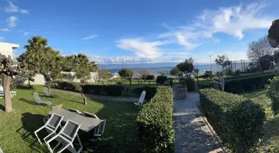a couple of chairs and a table in a yard at Petite villa le clan in Ajaccio