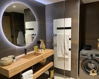a bathroom with a sink and a washing machine at Le Galatée Porticcio in Porticcio