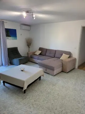 a living room with a couch and a coffee table at Bas de villa F3 proche Ajaccio in Cuttoli-Corticchiato
