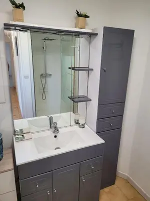 a bathroom with a sink and a mirror at Bas de villa F3 proche Ajaccio in Cuttoli-Corticchiato