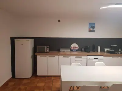 a kitchen with white cabinets and a white counter top at Bas de villa F3 proche Ajaccio in Cuttoli-Corticchiato