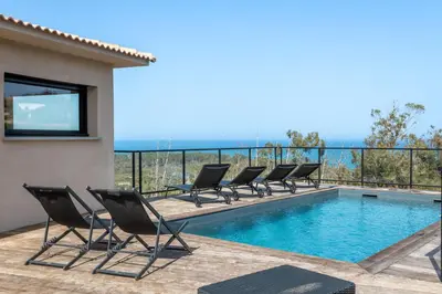 a patio with chairs and a swimming pool at Villa Kalinas Corse 4 étoiles in Sari Solenzara