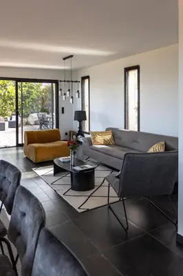 a living room with a couch and a table at Villa Kalinas Corse 4 étoiles in Sari Solenzara