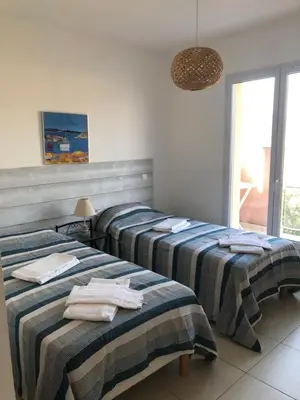 a room with two beds with towels on them at punta di buturetu in Propriano
