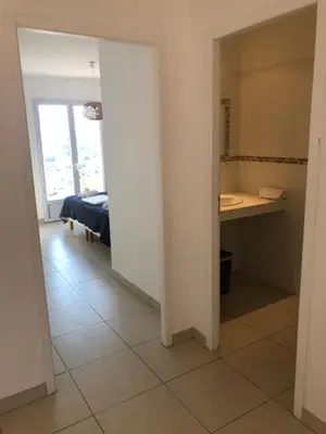 a hallway with a room with a bed and a desk at punta di prunetu in Propriano