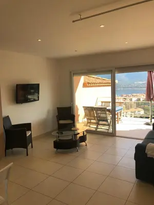 a living room with a couch and a table at punta di prunetu in Propriano