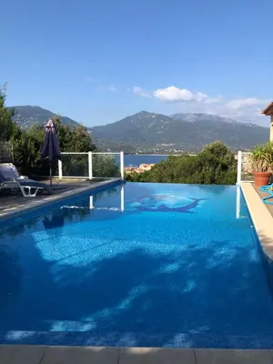 a swimming pool with a view of the water at punta di prunetu in Propriano