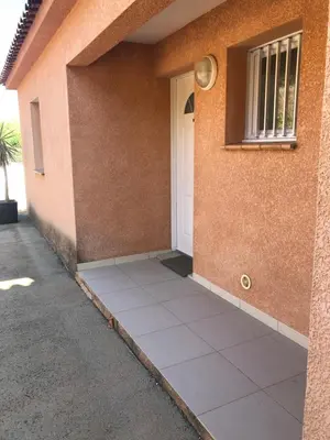 a side view of a house with a door at punta di prunetu in Propriano