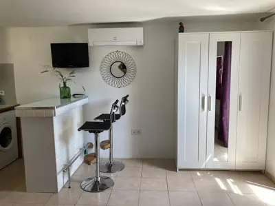 a kitchen with a counter and a sink and a stove at Studio à 200m du centre ville de Porto Vecchio,jardin, terrasse parking privé in Porto-Vecchio