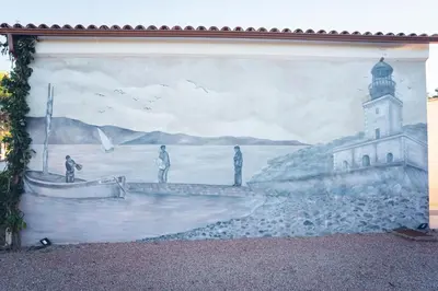 a mural on the side of a building with a lighthouse at Villa La Chiappa Bord de Mer avec piscine chauffée et Jacuzzi in Porto-Vecchio