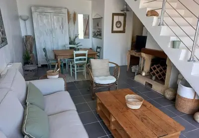 a living room with a couch and a table at Maison 3 chambres vue Mer in Grosseto-Prugna