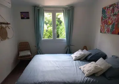 a bedroom with a large bed and a window at Maison 3 chambres vue Mer in Grosseto-Prugna