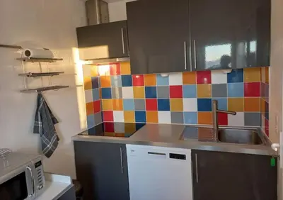 a kitchen with colorful tiles on the wall at Maison 3 chambres vue Mer in Grosseto-Prugna