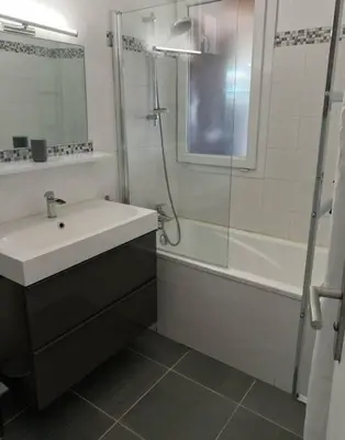a bathroom with a sink and a shower and a tub at Maison 3 chambres vue Mer in Grosseto-Prugna