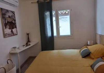 a bedroom with a large bed and a window at Maison 3 chambres vue Mer in Grosseto-Prugna