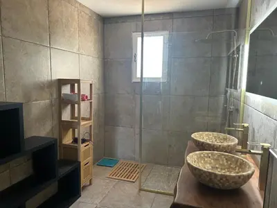 a bathroom with two sinks and a shower at Maison de charme en bord de mer in Lucciana