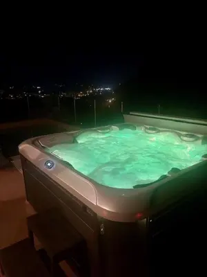 a bath tub filled with green water at night at La Casa San Biaggio in Ajaccio