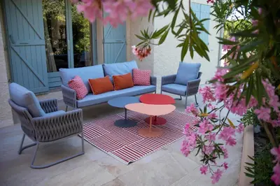 a patio with a couch and two chairs and a table at La Casa San Biaggio in Ajaccio
