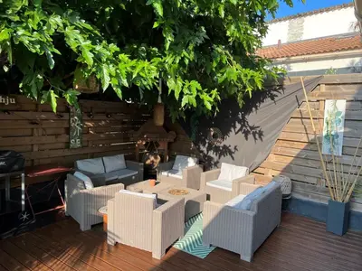 a patio with a table and chairs on a deck at Villa Ponticchio in Santa-Lucia-di-Moriani