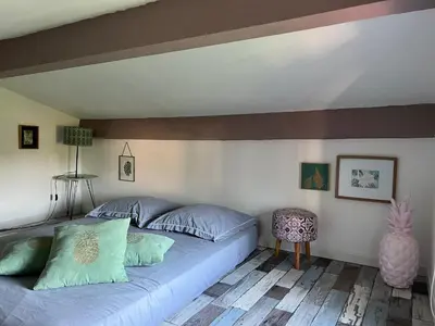 a bedroom with a bed with blue pillows at Villa Ponticchio in Santa-Lucia-di-Moriani