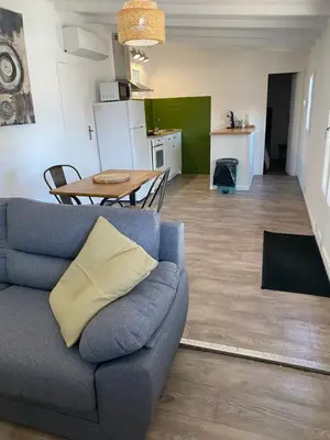 a living room with a couch and a table at Grand chalet d’été avec piscine in Bonifacio