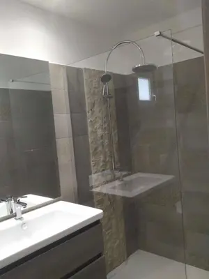 a bathroom with a glass shower and a sink at A Suara in Ghisonaccia