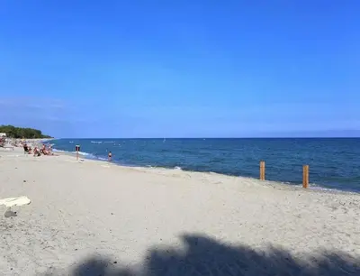 a group of people on a beach near the ocean at A Suara Di Mare in Ghisonaccia