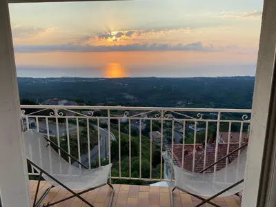 two chairs on a balcony with a view of the water at Villa tout confort, vue mer exceptionnelle, à Cervione in Cervione