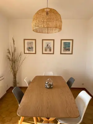 a dining room table with chairs and a chandelier at Villa tout confort, vue mer exceptionnelle, à Cervione in Cervione