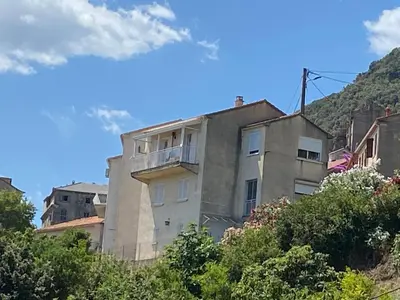 an apartment building on the side of a hill at Villa tout confort, vue mer exceptionnelle, à Cervione in Cervione