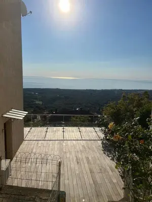 a view of a deck with the ocean in the background at Villa tout confort, vue mer exceptionnelle, à Cervione in Cervione