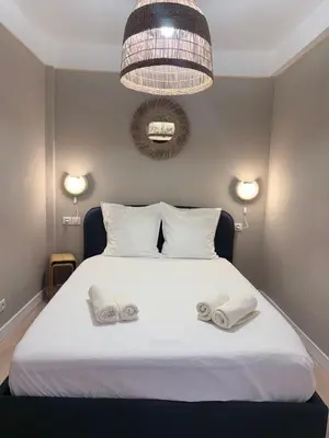 a bedroom with a white bed with towels on it at Charmant appartement in Ajaccio