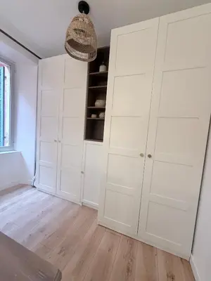 a white closet with white cabinets in a room at Charmant appartement in Ajaccio