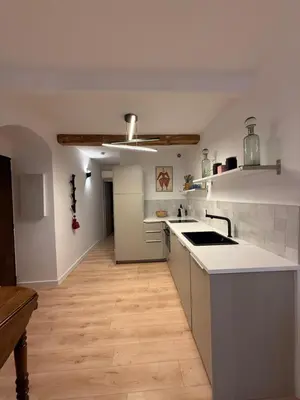 a kitchen with white counters and a white counter top at Charmant appartement in Ajaccio