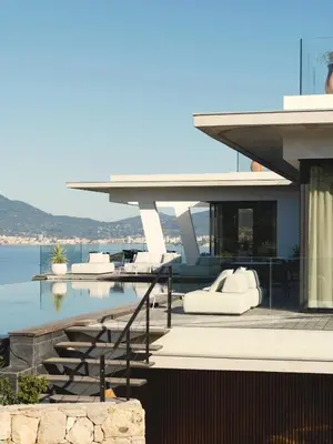 a house with a swimming pool with a view of the water at Villa Urbana in Porticcio