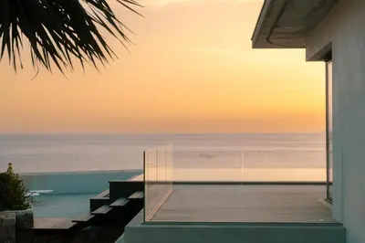 an empty house with a view of the water at Villa Urbana in Porticcio
