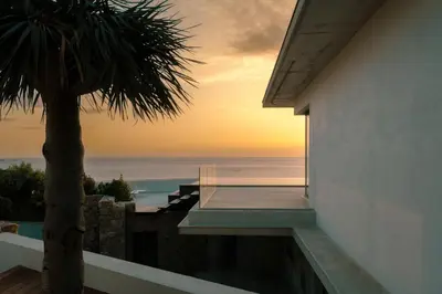 a view of the sunset from a house balcony at Villa Urbana in Porticcio