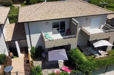 an aerial view of a house with a patio and umbrella at LA VILLA DE AUDREY MER ET MONTAGNE in Santa-Lucia-di-Moriani