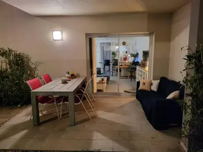 a living room with a table and a couch at LA VILLA DE AUDREY MER ET MONTAGNE in Santa-Lucia-di-Moriani